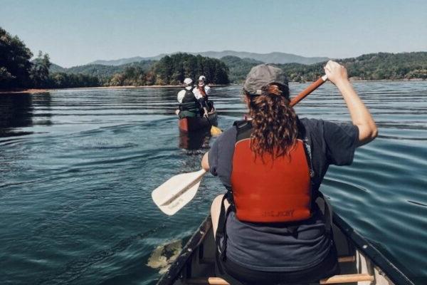 a group of people paddling on boats